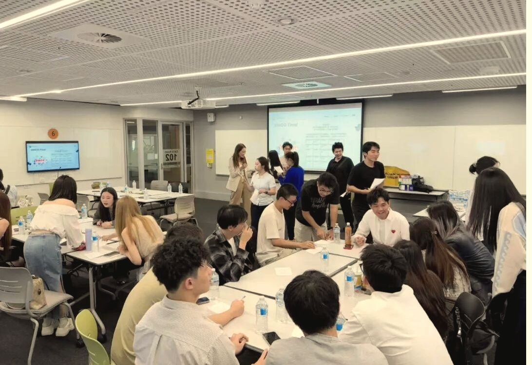 Students in small-group conversation with an industry guest
